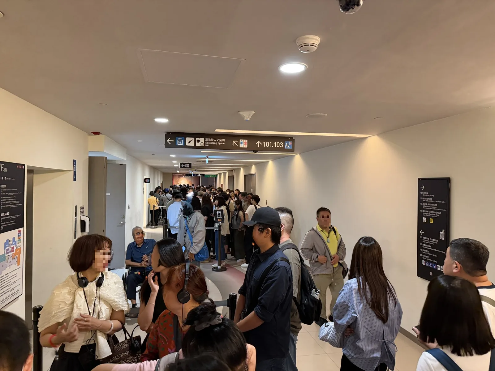 国立故宮博物院の館内通路にできた入館者の列。案内表示の下に人が奥まで並んでいる様子